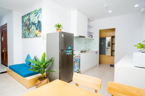 a kitchen with a stainless steel refrigerator and a table at Babylon D3 Serviced Apartment in Ho Chi Minh City