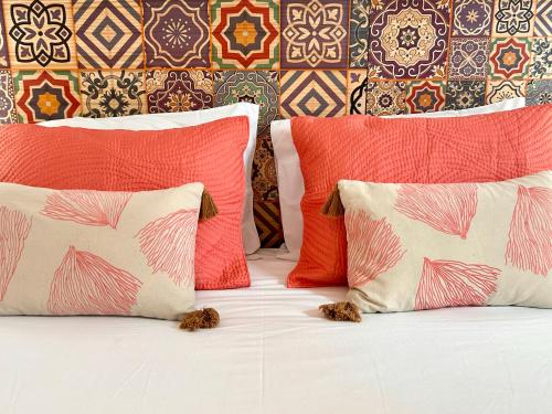a bed with four pillows on it with two at 262 Baixa Guesthouse in Lisbon