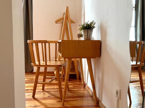 a wooden table with a chair and a wooden instrument at 262 Baixa Guesthouse in Lisbon