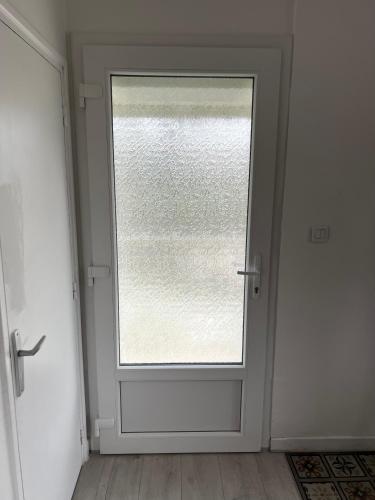 a door with a window in a room at Orgîte in Juvigny-sur-Marne
