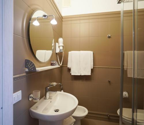 a bathroom with a sink and a mirror and a toilet at Sole Mare in Ventimiglia