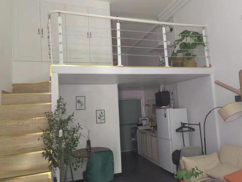 a living room with a loft bed and a kitchen at Shanghai Garden Apartment - Near Downtown Wukang Road in Shanghai