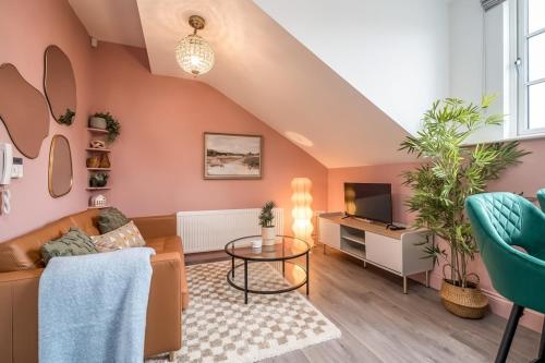 a living room with a couch and a tv at Central Belfast Apartments: Botanic in Belfast