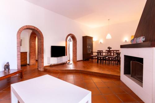 a living room with a fireplace and a tv at Vista Mare by DomuSicily in Cinisi