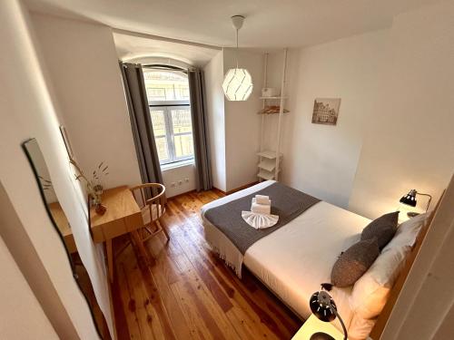 a small bedroom with a bed and a window at 262 Baixa Guesthouse in Lisbon