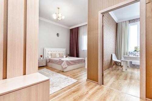 a bedroom with a bed and a mirror at Красивые апартаменты на Экспо in Taldykolʼ