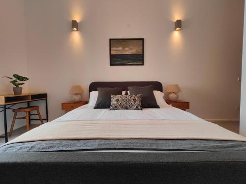 a bedroom with a large bed with a pillow on it at Sbejha Guest House in Naxxar