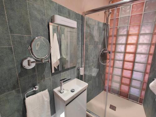 a bathroom with a shower and a sink and a mirror at Sbejha Guest House in Naxxar