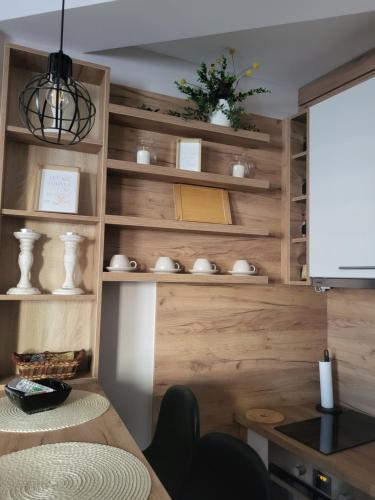 a kitchen with wooden walls and a table and chairs at Regina S in Jagodina