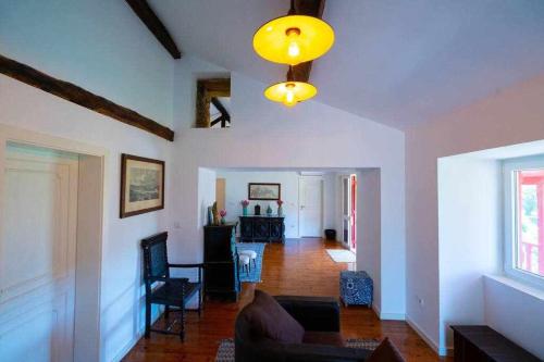 a living room with a couch and a chandelier at Quinta da Pousada Casa de Campo in Santa Marta de Penaguião