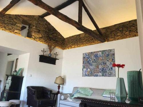 a living room with a couch and a stone ceiling at Quinta da Pousada Casa de Campo in Santa Marta de Penaguião