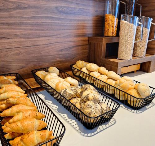 four baskets of breads and other pastries on a table at Hotel Alkar in Sinj