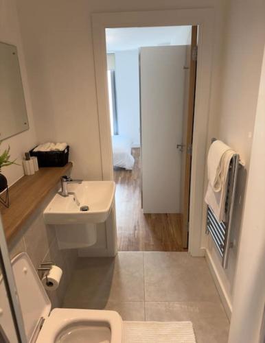 a white bathroom with a sink and a toilet at Your private oasis in Manchester in Manchester