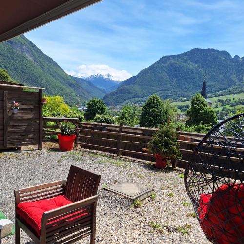 a patio with chairs and a view of mountains at Appartement avec terrasse et parking Privé in Aigueblanche