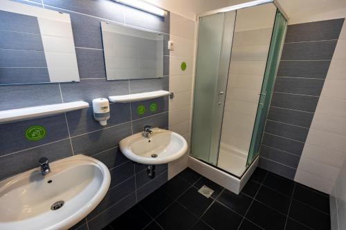 a bathroom with a sink and a mirror at Hostel Velenje in Velenje