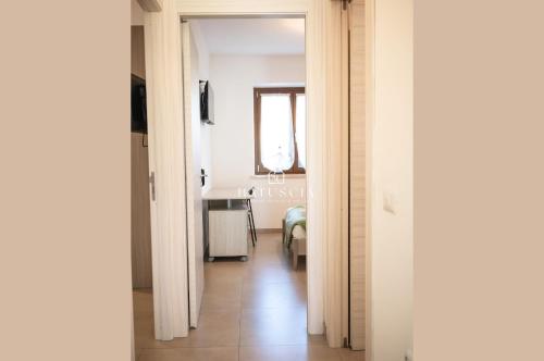 a hallway leading to a room with a bed at Natuscia Trevignano - Francesconi Villa with Garden in Trevignano Romano