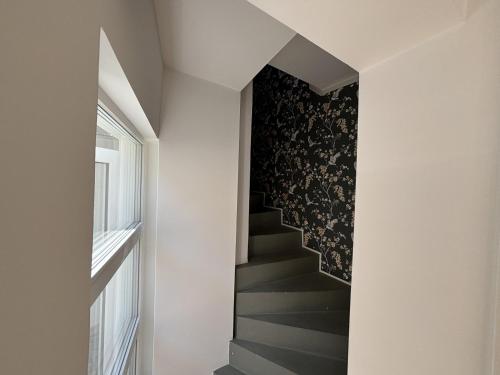 a staircase with a black and white patterned wall at Work & Relax in Maintal in Maintal