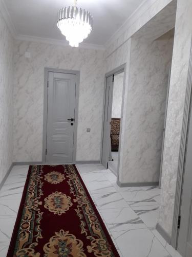 a hallway with a red rug and a white door at Apartment 2хкомнатрая квартира in Osh