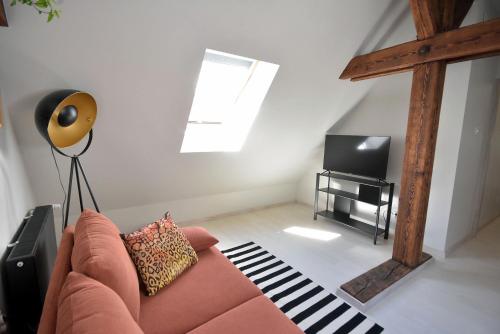 a living room with a couch and a tv at Apartamenty Basztowa in Świdnica
