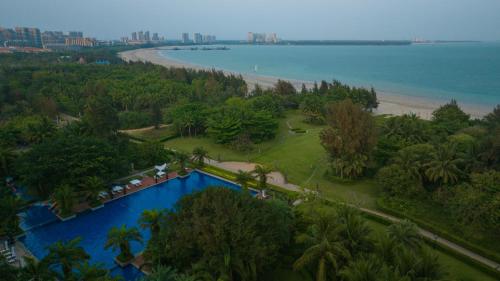 an aerial view of a resort with a swimming pool and a beach at Wyndham Garden Wenchang Nanguo in Wenchang