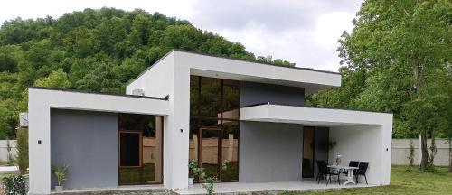 a white house in front of a mountain at Harmony Hideaway in Gabala