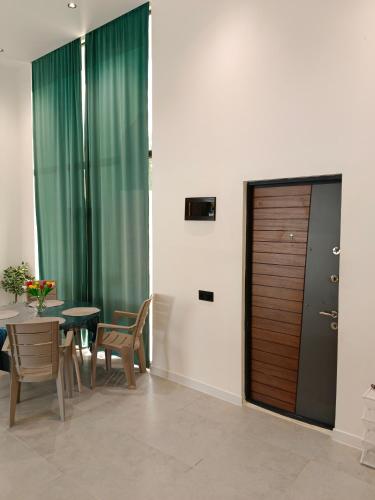 a dining room with a table and a wooden door at Harmony Hideaway in Gabala