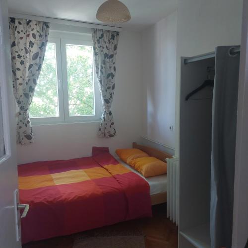 a bedroom with a bed and a window at Apartment ADA RB Belgrade in Čukarica