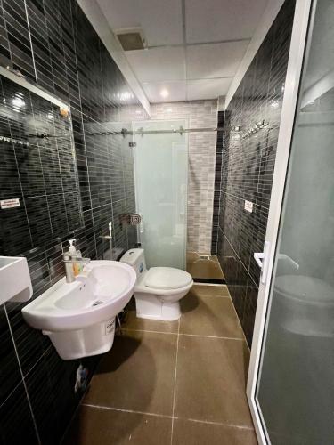 y baño con aseo, lavabo y ducha. en Khách Sạn Trung Anh 78 HAI BÀ TRƯNG BMT, en Buon Ma Thuot