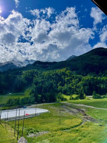a view of a road with mountains in the background at Hotel Biancaneve in Cogolo