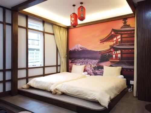 two beds in a room with a painting on the wall at Free Style Hotel Dalat in Da Lat
