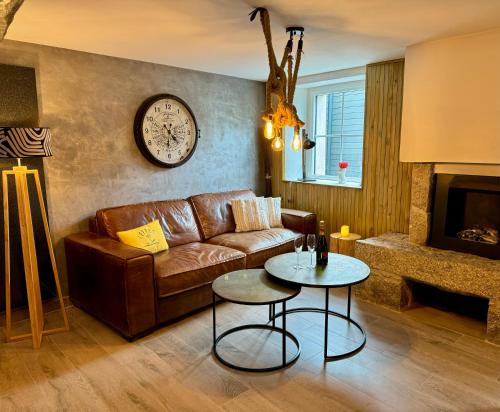 a living room with a couch and a table at Maison de vacances atypique in Guérande