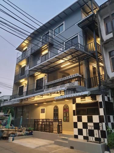 a tall building with a checkered building at Gail's Hostels in Bangkok