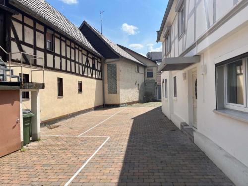 an alley between two buildings with a brick sidewalk at Work & Relax in Maintal in Maintal