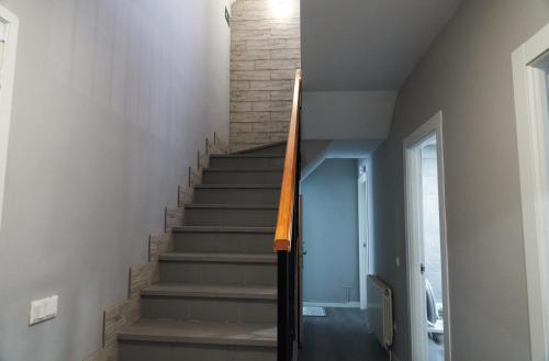 a staircase in a house with a brick wall at VILLA Formonte in Los Ángeles de San Rafael