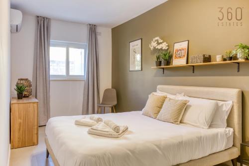 Un ou plusieurs lits dans un hébergement de l'établissement Urban Square Elite Suites by 360 Estates