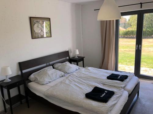 a bedroom with a bed with two black towels on it at Bunker 35 in Kevelaer