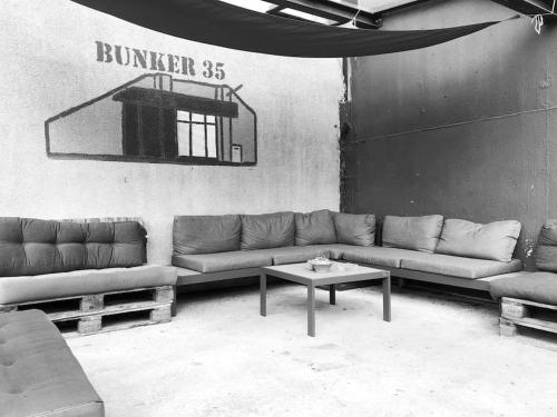 a living room with couches and a basketball hoop at Bunker 35 in Kevelaer