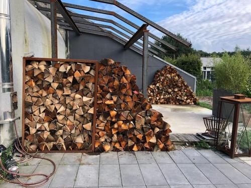a pile of fire wood sitting next to a building at Bunker 35 in Kevelaer