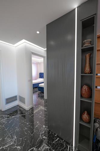 a living room with a marble floor and a wall at New Beach Suite in Sarandë