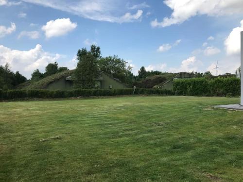 a large lawn with a house in the background at Bunker 35 in Kevelaer