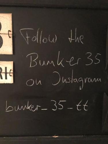 a chalkboard with writing on the side of a wall at Bunker 35 in Kevelaer