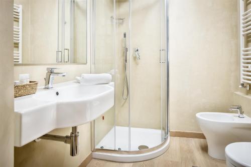 a bathroom with a sink and a shower at Hotel Italia in Cagliari