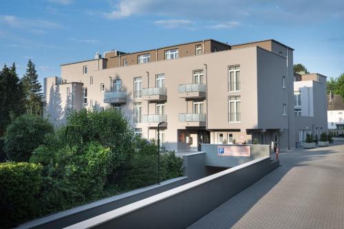 a rendering of a building from the street at Atrium Apart Hotel Brühl in Brühl