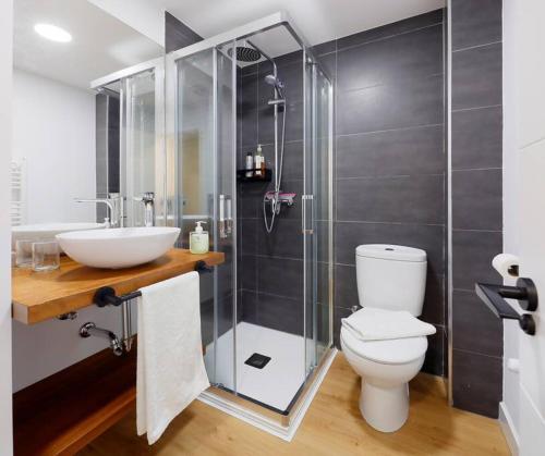 a bathroom with a sink and a toilet and a shower at Magnifico apartamento en Llanes in Llanes