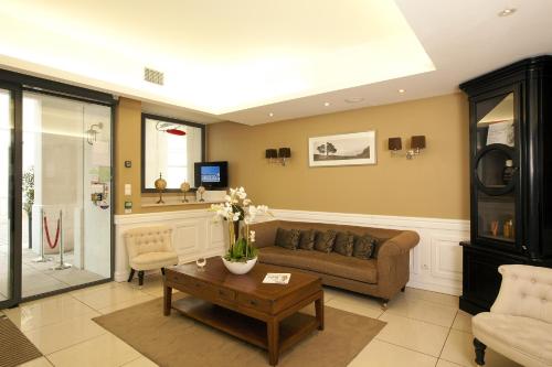 a living room with a couch and a table at Residhome Arcachon Plazza in Arcachon