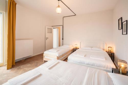 Ένα ή περισσότερα κρεβάτια σε δωμάτιο στο Two-Bedroom Apartments in the Heart of Antwerp