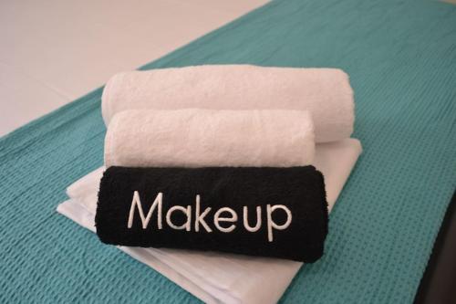 a stack of towels with the word make up on them at Yalos Studio in Stavros