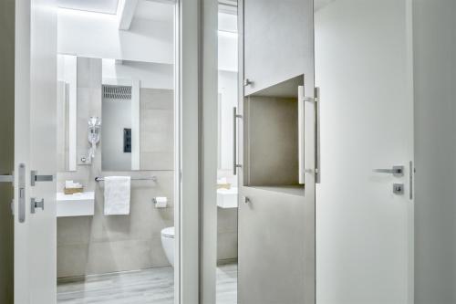 a bathroom with a toilet and a sink at Hotel Italia in Cagliari