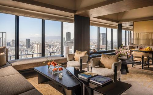 a living room with a view of a city at Four Seasons Hotel Osaka in Osaka