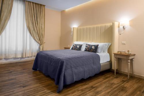 a hotel room with a bed and a window at Onda Marina Suites in Cagliari